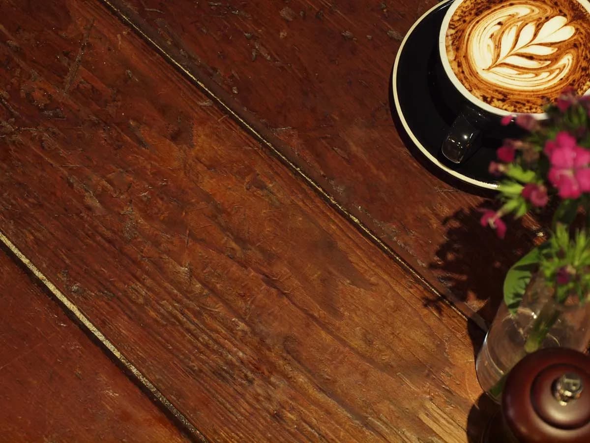 Rustic seating area with flowers and aged wooden wall panels